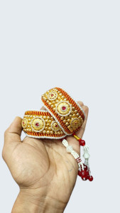 Traditional Rajasthani Gold-Plated pouchi with Ruby Accents & Pearl Border