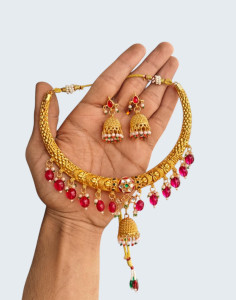 Traditional Textured Gold-Plated Hasli Choker with Central Jhumka & Ruby Beads